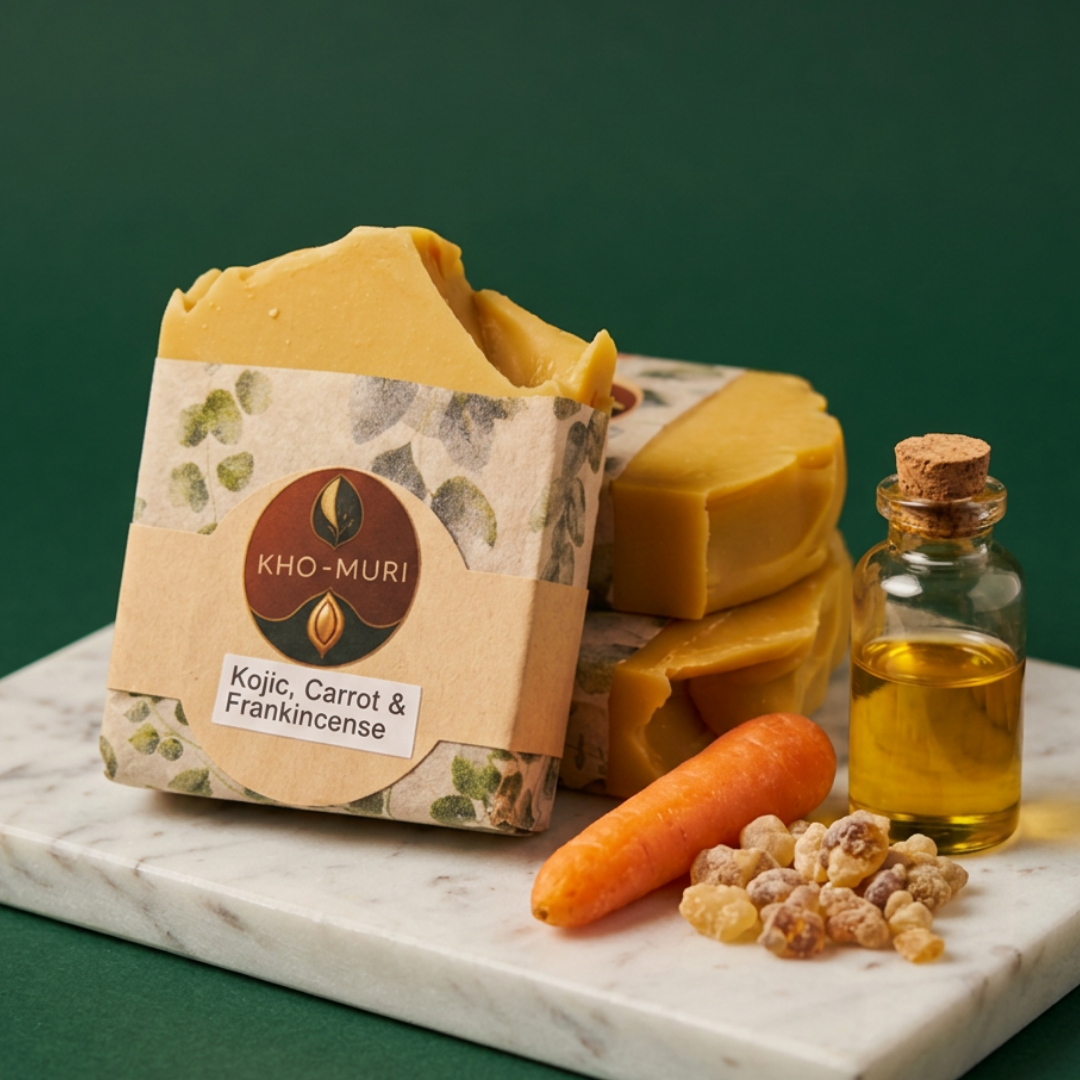 Kho-Muri soap with carrot and frankincense on a marble slab against a green background
