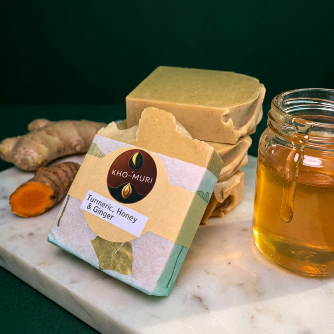 Kho-Muri soap with turmeric, honey, and ginger on a marble surface with a dark background